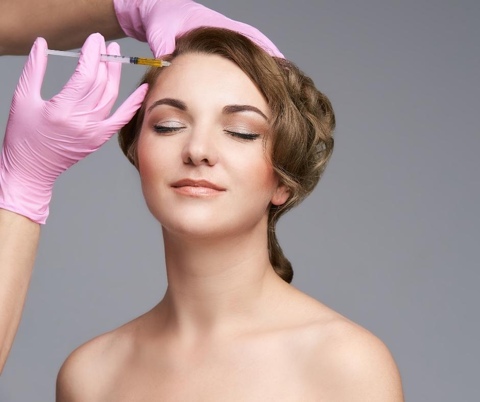 Female patient getting preventative Botox injections on forehead as a Christmas gift.